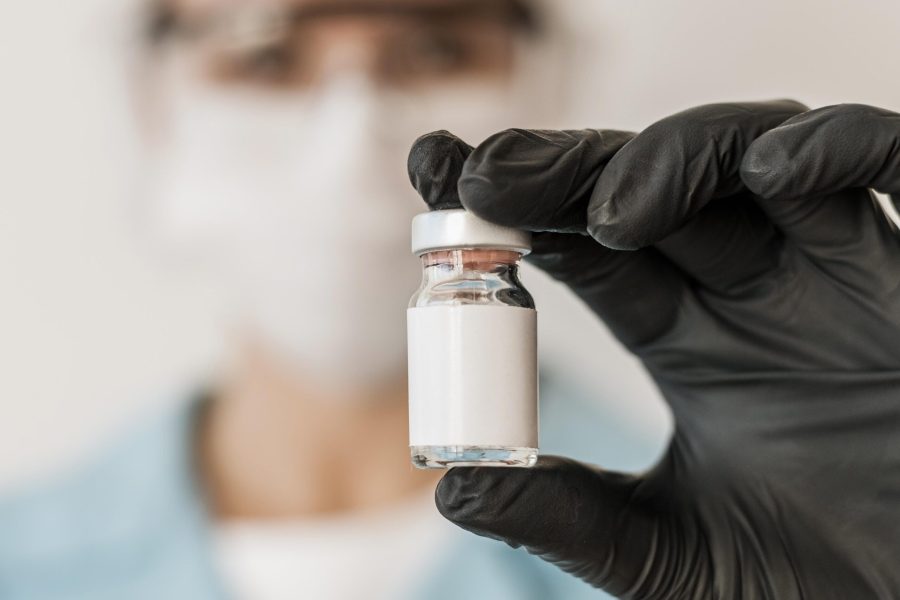 defocused-female-doctor-with-vaccine