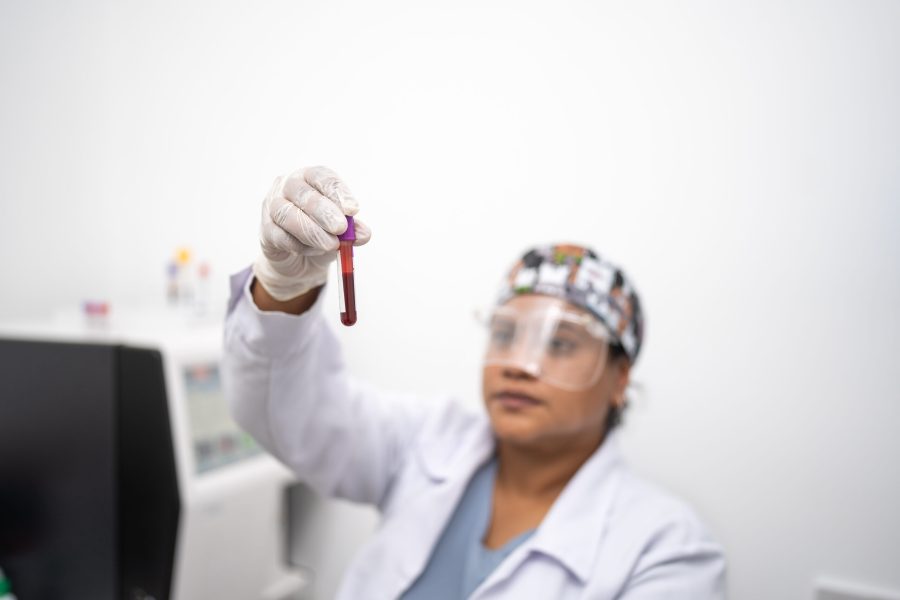 Female lab technician observing that the blood sample is in good condition in a test tube.