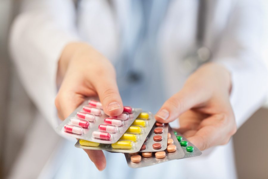 Pills in female hands, close-up view