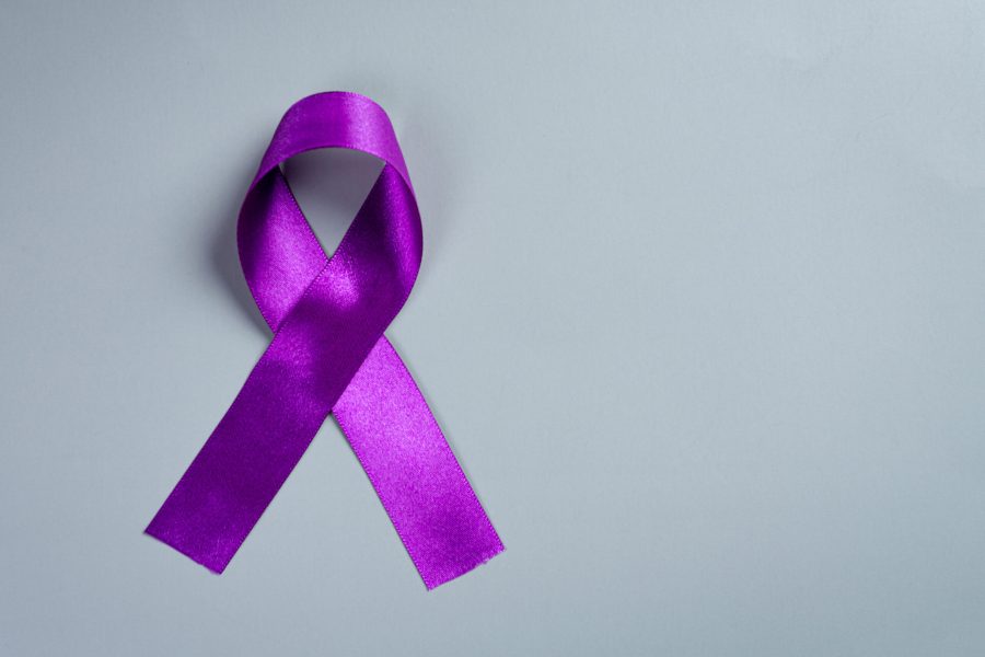 Purple ribbon on the wooden background.