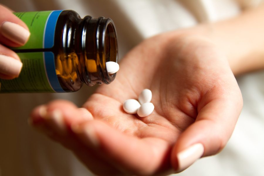 Woman pours the pills out of the bottle